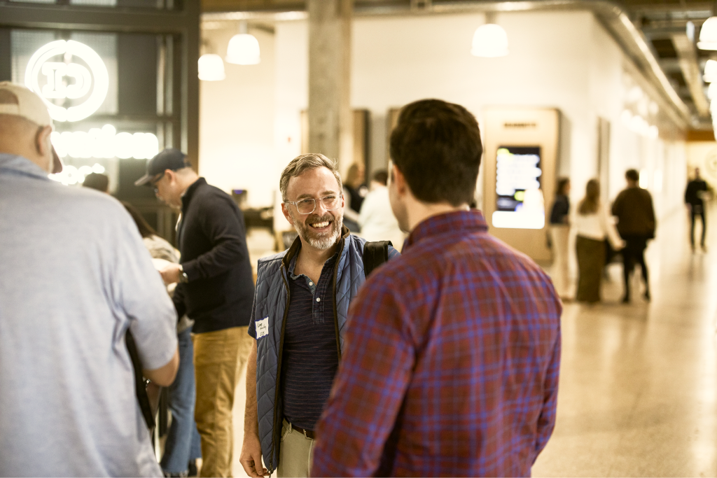 Two volunteers talking at a Birmingham AI event